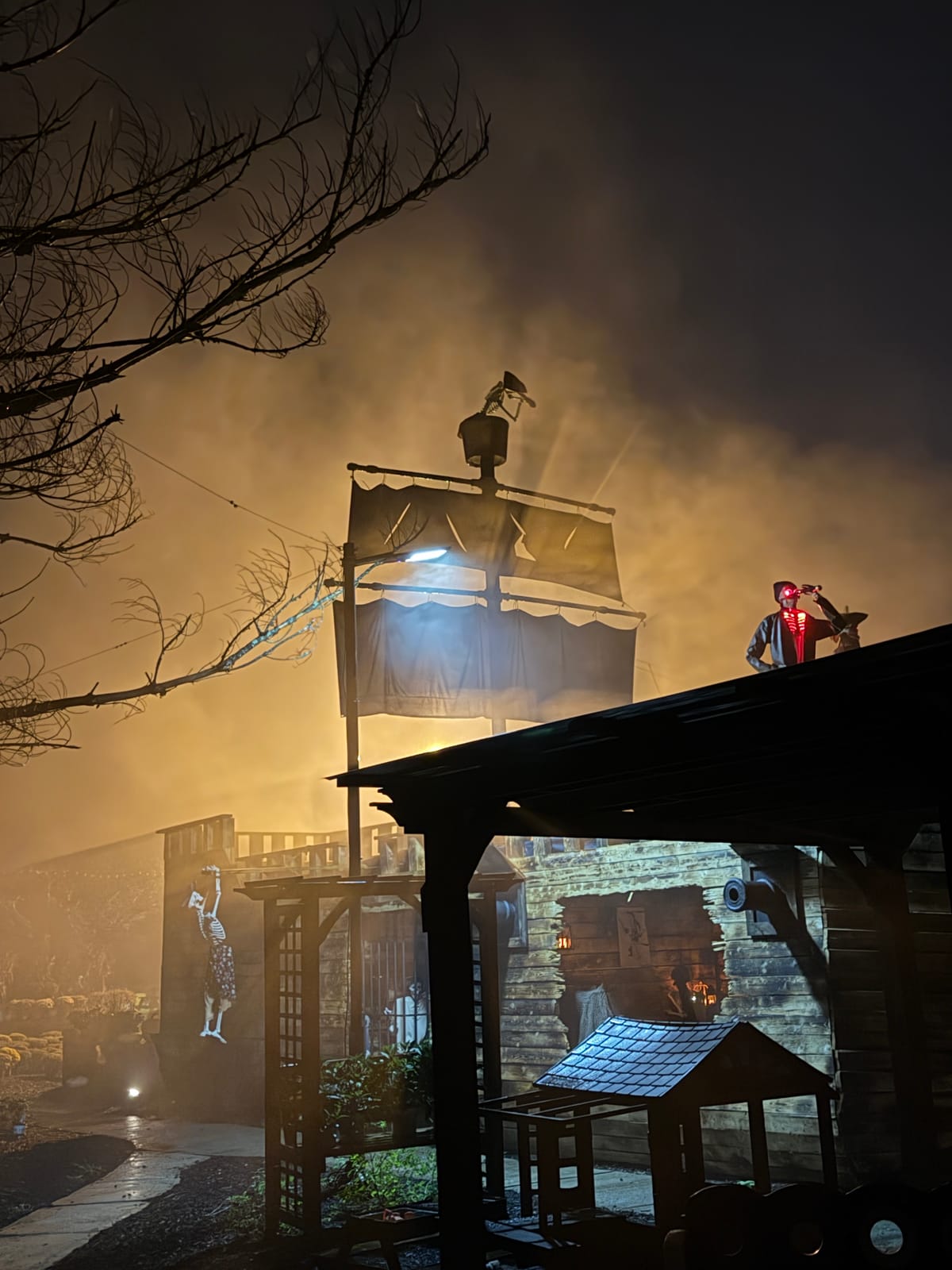 The pirate ship in fog at night, with a skeleton lookout on the roof
